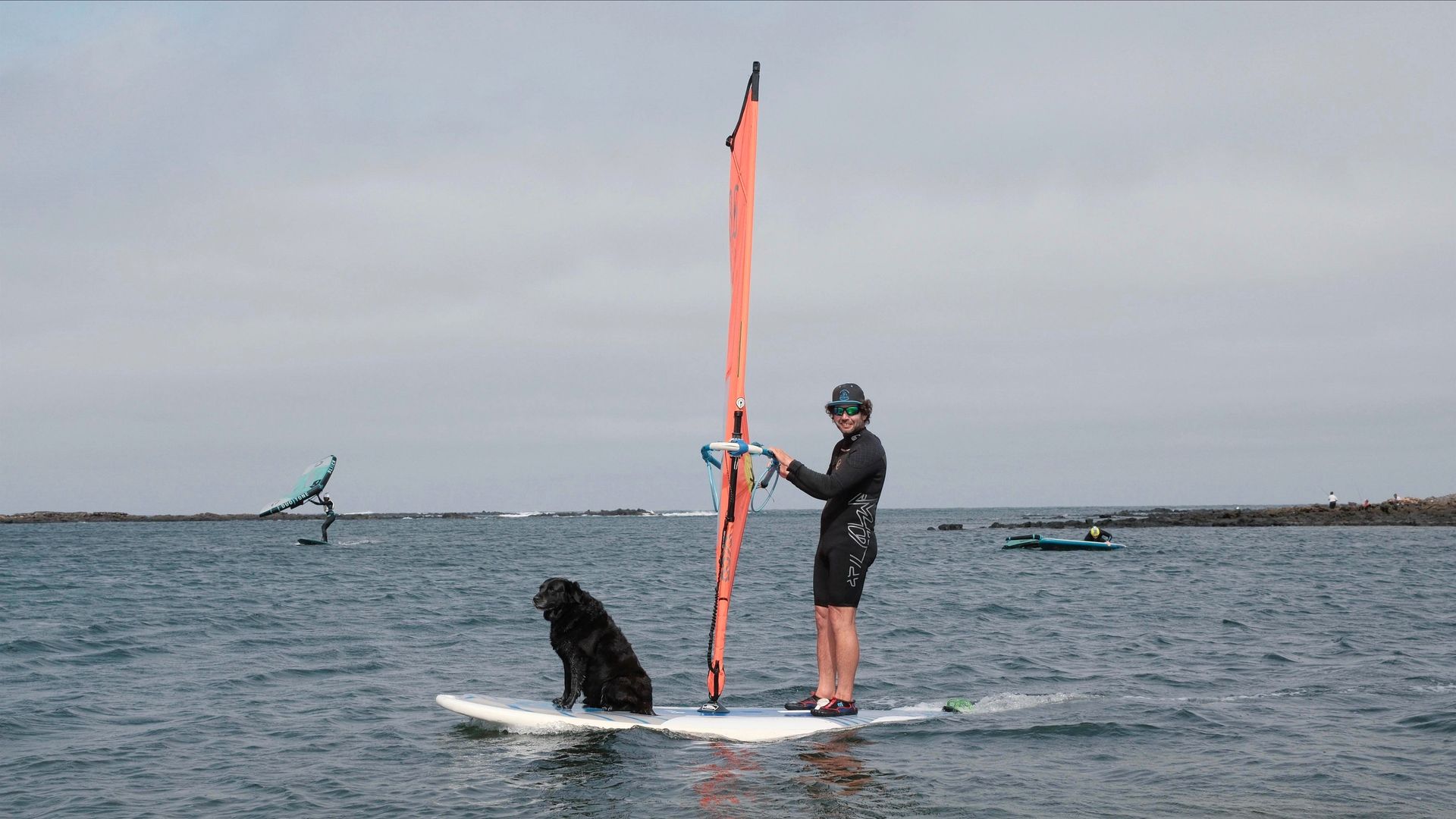 Shadow standing on the bow of a windsurf board